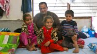  Gaylan and his children in their temporary shelter in Hasansham camp.