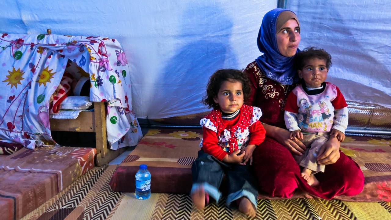 A woman and her children in their tent in Khazer camp, where tens of thousands of IDPs have been living since the 17th October.