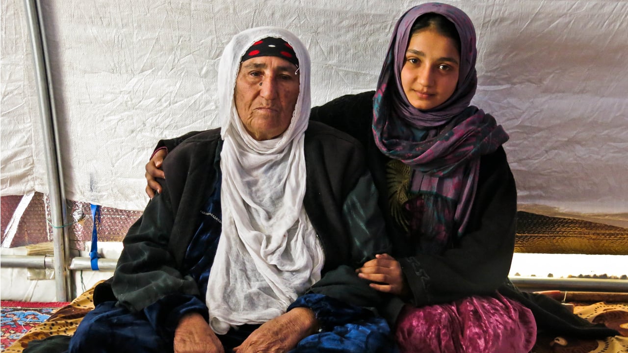 Reema with her granddaughter Dhoha in their tent in  Khazer camp. 