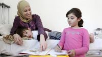 Haya, a  SYrian refugee, with her two children.