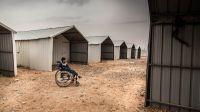 A  Syrian child sitting in a wheelchair in Azraq camp, Jordan.