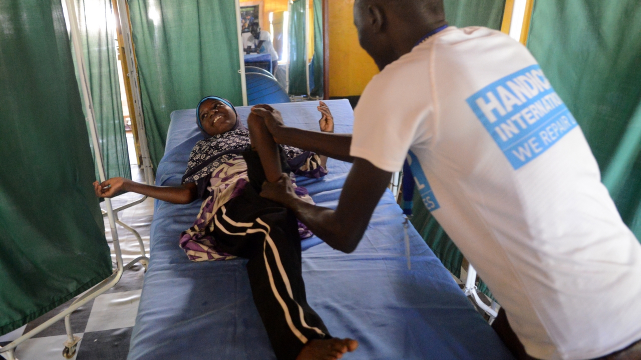 Halima, 9, in a rehabilitation session with a Handicap International physical therapist.