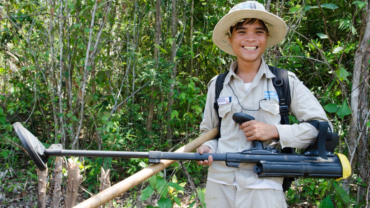 Nouay shows the tools he uses to clear UXO. 