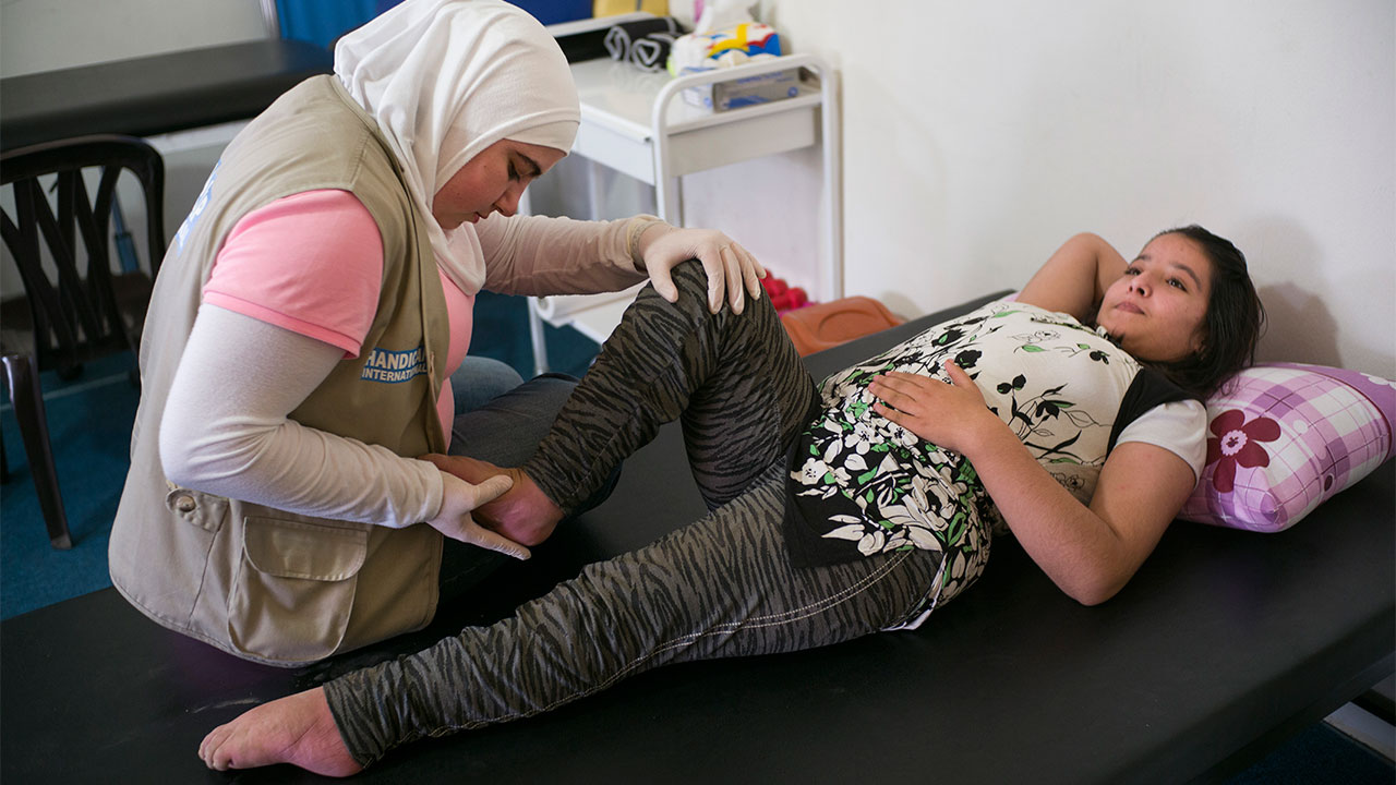 Bayan and Narimane during a physical therapy session in a rehabilitation center equipped by Handicap International, Lebanon.