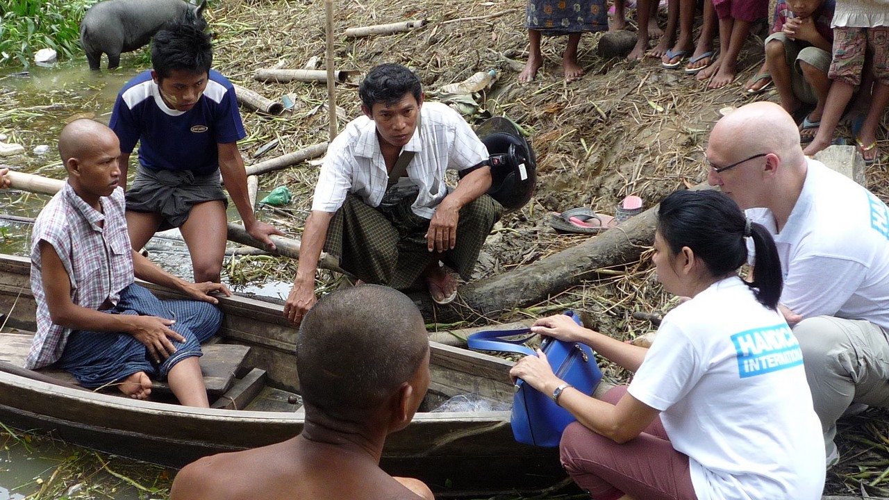 Eric Weerts and the Handicap International team conduct a situation assessment for a person with disabilities who needs to use a boat to reach his home from the road due to the floods. Myanmar