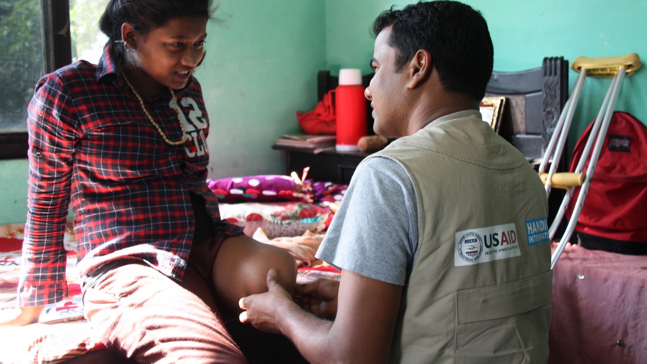 Earthquake survivor, Priya, 14, during a rehabilitation session with a Handicap International physical therapist.