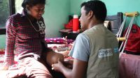 Earthquake survivor, Priya, 14, during a rehabilitation session with a Handicap International physical therapist.