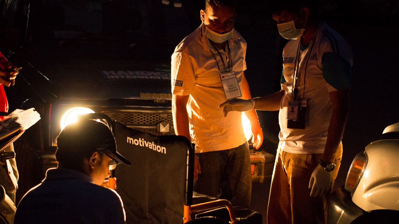 Handicap International staff working overnight to assemble wheelchairs that will be used to transfer patients at the Teaching Hospital in Nepal.