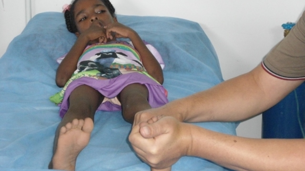 A child receiving care from Handicap International's mobile team