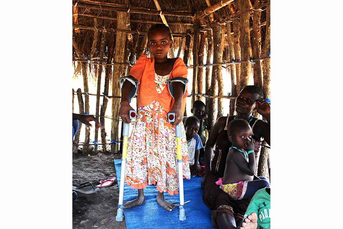 Tabith standing with her new crutches