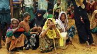  Women in a refugee camp waiting for food aid